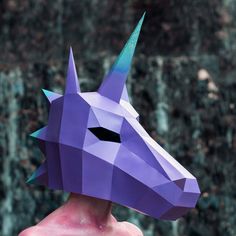 an origami unicorn's head is shown in front of a wall with waterfall