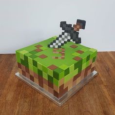 a cake made to look like an image of a person on a green blocky surface