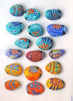 colorful painted rocks are arranged in the shape of fish