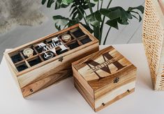 two wooden boxes sitting on top of a table