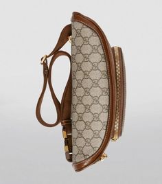 The distinctive GG Supreme motif has been a defining feature of all of Gucci’s collections since the 1930s; here it’s emblazoned on durable canvas for the label’s recurring belt-bag silhouette. Sleek and compact, it has a discreet zipped pocket, chunky gold-tone hardware and an adjustable strap you can wear across the body or around the waist for a utilitarian look. Vintage Gucci Bag With Removable Pouch, Brown Leather Gucci Belt Bag, Gucci Beige Bag With Logo, Gucci Brown Leather Belt Bag, Vintage Brown Gucci Bag, Brown Leather Trim Belt Bag For Travel, Gucci Leather Belt Bag With Removable Pouch, Luxury Travel Belt Bag With Logo, Gucci Belt Bag With Removable Pouch For Travel