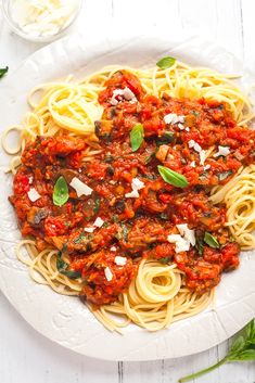 a white plate topped with pasta covered in sauce