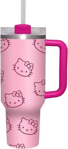 a pink cup with hello kitty designs on it and a straw sticking out of the lid