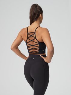 Features: High neckline Lattice back strap detail Removable bust pads Cropped fit Details: Fabric: Energy (Nylon/Spandex) Light — Medium Support Description: This Ivy Crop has a removable bust pads, a high neckline, and a cropped length. The back features a lattice back strap detail and it is made with our Energy fabric for light compression and an ultra-soft, breathable feel. Fitted Tank Top With Built-in Bra And Cross Back, High Stretch Strappy Sports Bra, Fitted Tank Top With Built-in Bra And Strappy Back, Functional Fitted Sports Bra With Cross Back, Fitted Strappy Nylon Sports Bra, Fitted Cross Back Activewear With Straps, Fitted Cross-back Activewear With Straps, Fitted Nylon Activewear With Straps, High Stretch Strappy Back Sports Bra