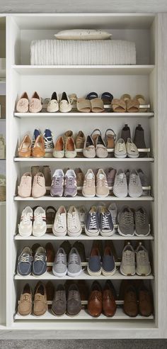 a white closet filled with lots of shoes