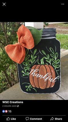 a black mason jar with a pumpkin on it and the words, wsc creations