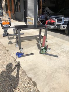 two work benches sitting on the side of a road next to a building and a truck