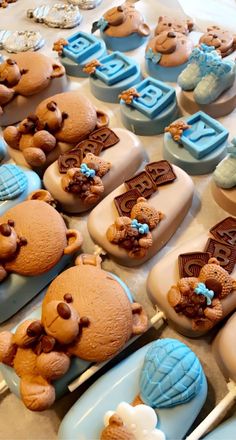 there are many cupcakes that have teddy bears on them with blue frosting