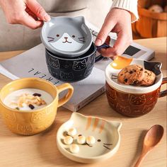 a person is scooping some food out of a cat shaped container with spoons