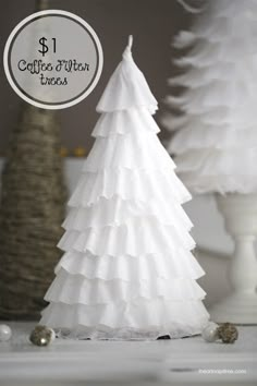 a white paper christmas tree sitting on top of a table