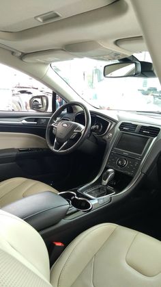 the interior of a car with white leather seats