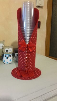 a red and white vase sitting on top of a table