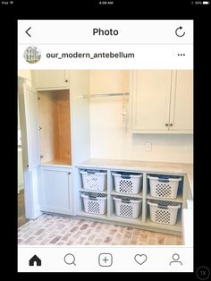 an instagram photo of a laundry room with white cabinets and baskets on the floor