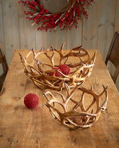 antlers and berries sit on a wooden table