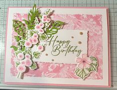 a birthday card with pink flowers and green leaves