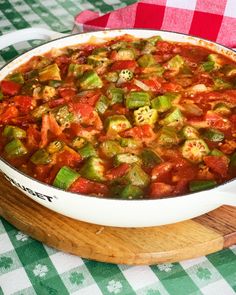 a large casserole dish with tomatoes and green peppers