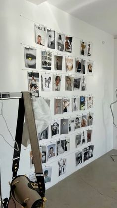 a white wall with pictures on it and a bag hanging up against the wall in front of it