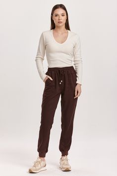 image of a female model wearing a JACEY SUPER HIGH RISE CROPPED JOGGER PANTS GROUND COFFEE DEAR JOHN DENIM Tencel Denim, Denim Essentials, Comfy Wear, Cropped Joggers, Jumpsuit Jacket, Ground Coffee, Medium Wash Jeans, Comfy Sweaters, Sweater Sale