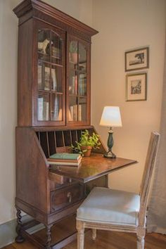 a wooden desk with a book shelf and chair