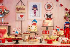 a table topped with lots of cakes and desserts