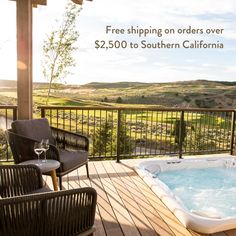 a hot tub sitting on top of a wooden deck next to a table and chairs