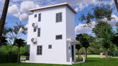 a small white house sitting in the middle of a lush green field with palm trees