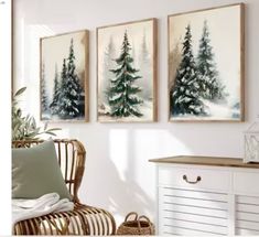 three paintings hang on the wall above a wicker chair in a white living room