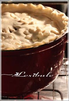 a close up of a pie in a pan on a rack with the word beautiful written below it