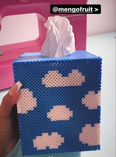 someone is holding up a tissue box made out of legos that look like clouds