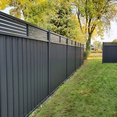 a black fence in the middle of a grassy yard