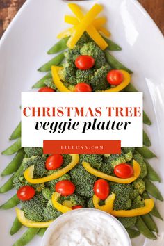 a christmas tree veggie platter with ranch dip and vegetables on the side