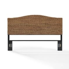 an upholstered headboard with black metal legs and wicker backrests