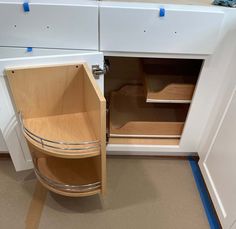 an open cabinet in the corner of a kitchen