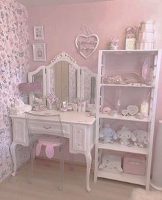 a pink and white bedroom with teddy bears on the desk, shelves and dressers