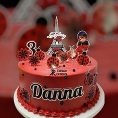 a cake decorated with ladybugs and the eiffel tower in paris, france