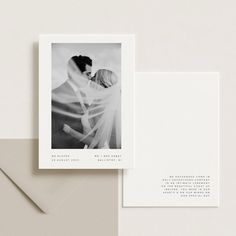 an image of a couple kissing on their wedding day with the save the date card in front