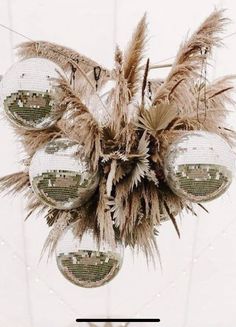 a chandelier hanging from the ceiling with feathers on it