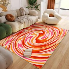 a living room filled with furniture and a colorful rug on top of a hard wood floor