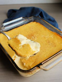 a spoon in a casserole dish with cream on top