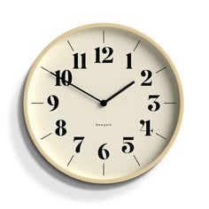 a black and white clock with numbers on the face is shown against a white background