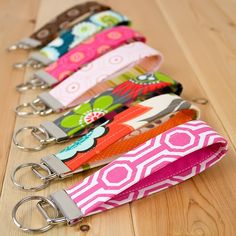 six key fobs lined up on a wooden floor