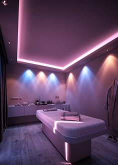 a room that has some lights on the ceiling and white furniture in front of it