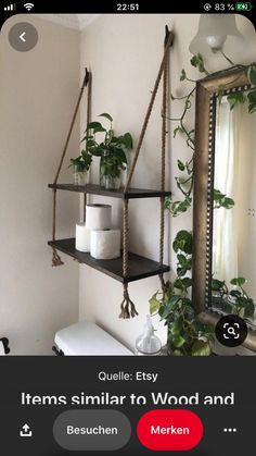 the bathroom is decorated with plants and hanging shelves