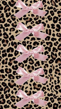 an animal print with pink bows on it