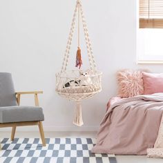 a bedroom with a hammock hanging from the ceiling and pillows on the floor