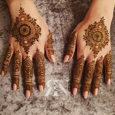 two hands with henna designs on them