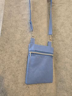 This bag was handcrafted using metallic blue fabric and a Sallie Tomato pattern. The strap is adjustable so it can be a crossbody bag or a shoulder bag. The hardware is nickel and includes 1 zipper and 1 back pocket. It also has removable strap clips. Finished size is about 12" x 8.5". Each bag in our shop is handmade in Arizona by the two of us at Denzi. We make sure to carefully craft each bag so that it is durable and will allow you to carry everything you need comfortably. If you like one of our designs, but would like it in a different color, please feel free to message us or email denzibags@gmail.com. Blue Crossbody Shoulder Bag With Zipper Pouch, Sallie Tomato, Sling Bags, Metallic Blue, Blue Fabric, Back Pocket, Cross Body Handbags, Purses And Handbags, Crossbody Bags