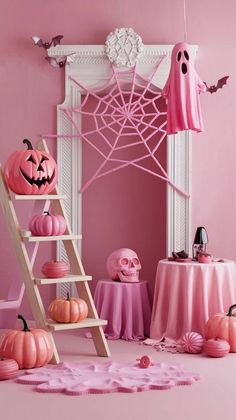 a pink room decorated for halloween with pumpkins