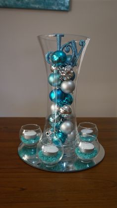 a glass vase filled with blue and white ornaments