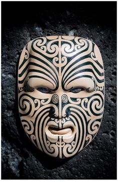 a white mask with black designs on it